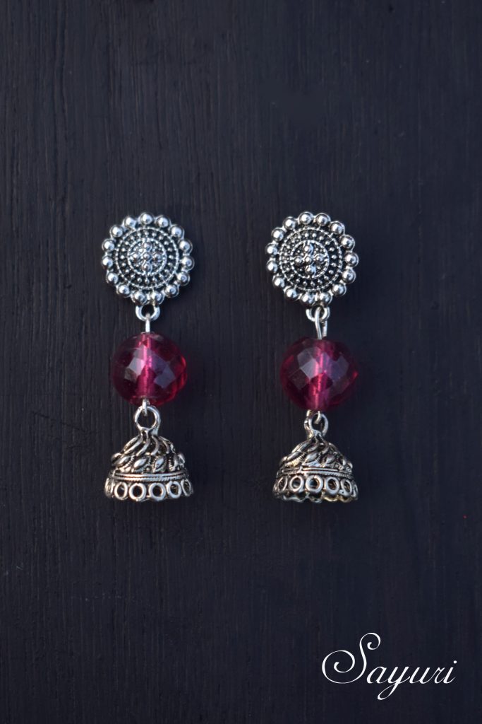 A glass of red earrings