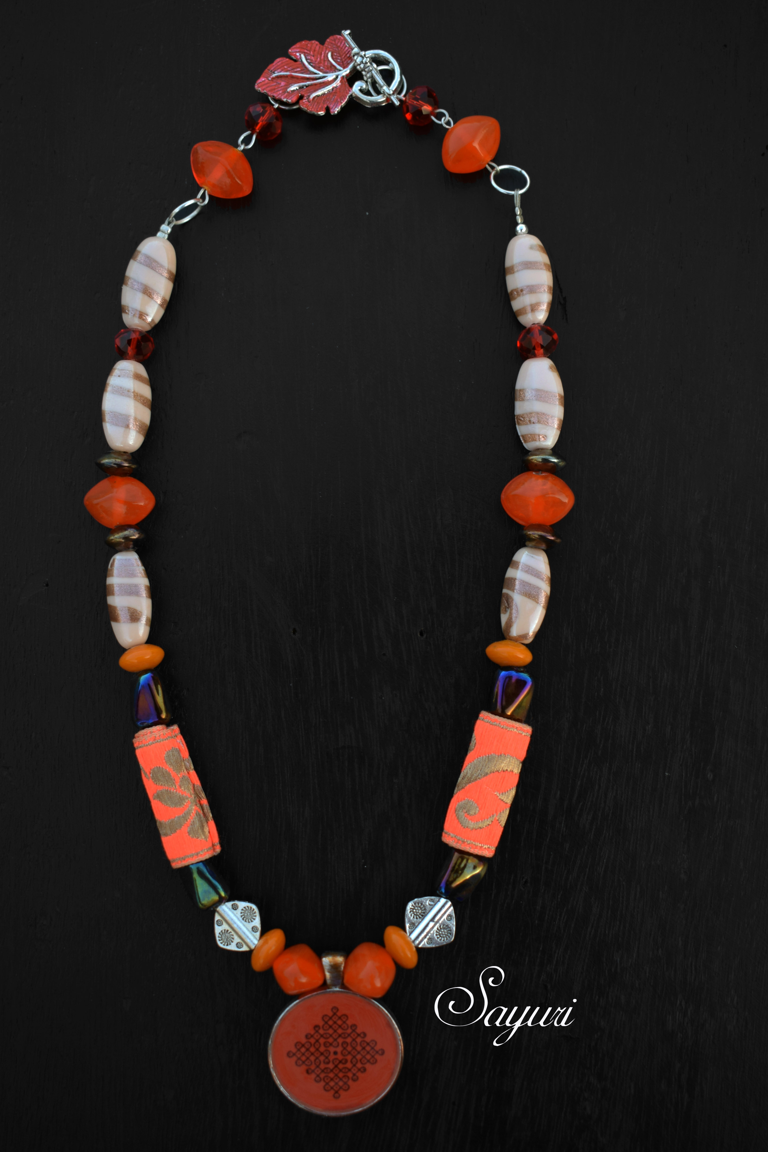 orange and offwhite kolam necklace. Analogous Pulli Kolam necklaces by Sayuri
