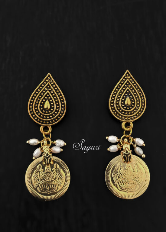 Golden earrings for a photo shoot